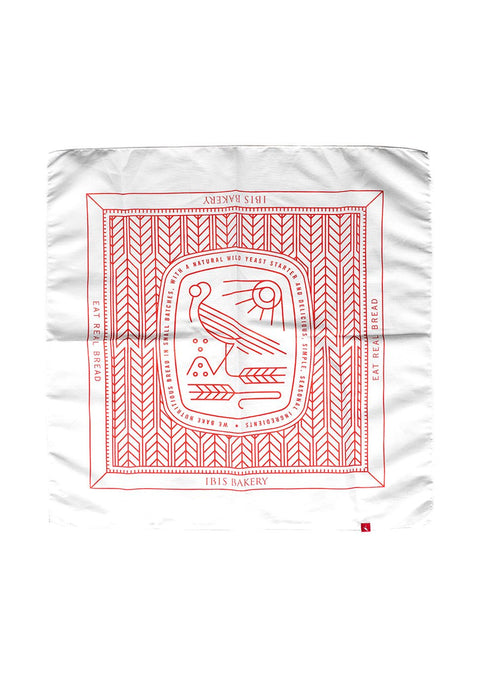 IBIS Bandana featuring white fabric with red geometric pattern and stylized bird logo in traditional bandana design layout