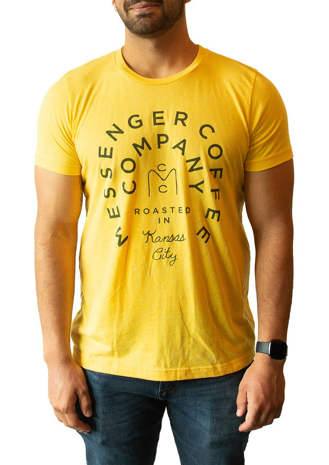 Yellow t-shirt with Messenger Coffee Company circular logo and Kansas City text printed in black, showing classic badge design