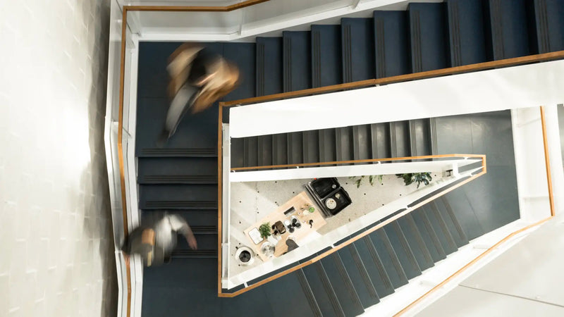 Aerial view of a modern staircase with a with a coffee counter below