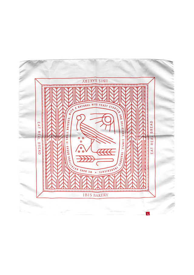 IBIS Bandana featuring white fabric with red geometric pattern and stylized bird logo in traditional bandana design layout